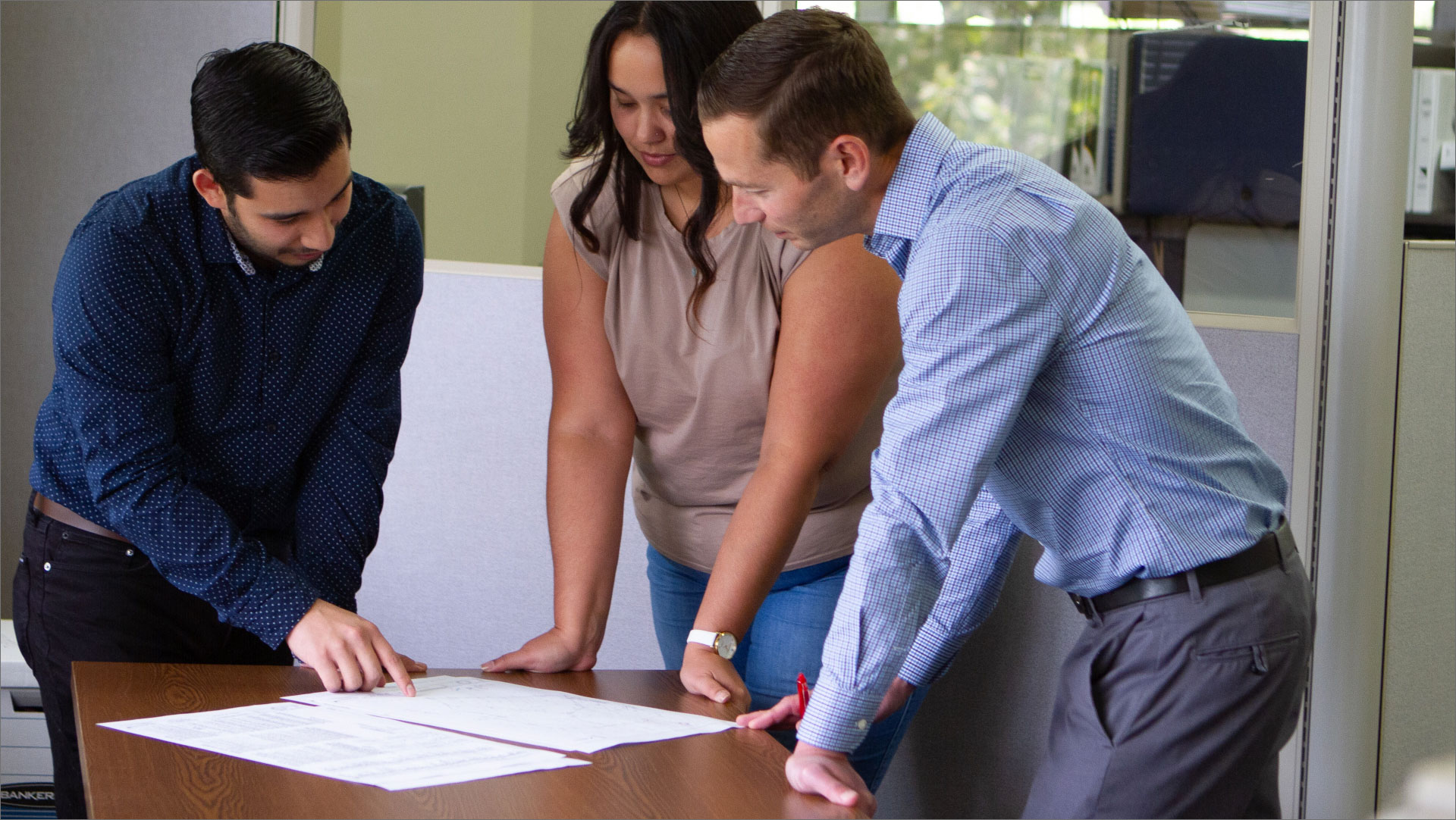 Engineers looking over a set of plans