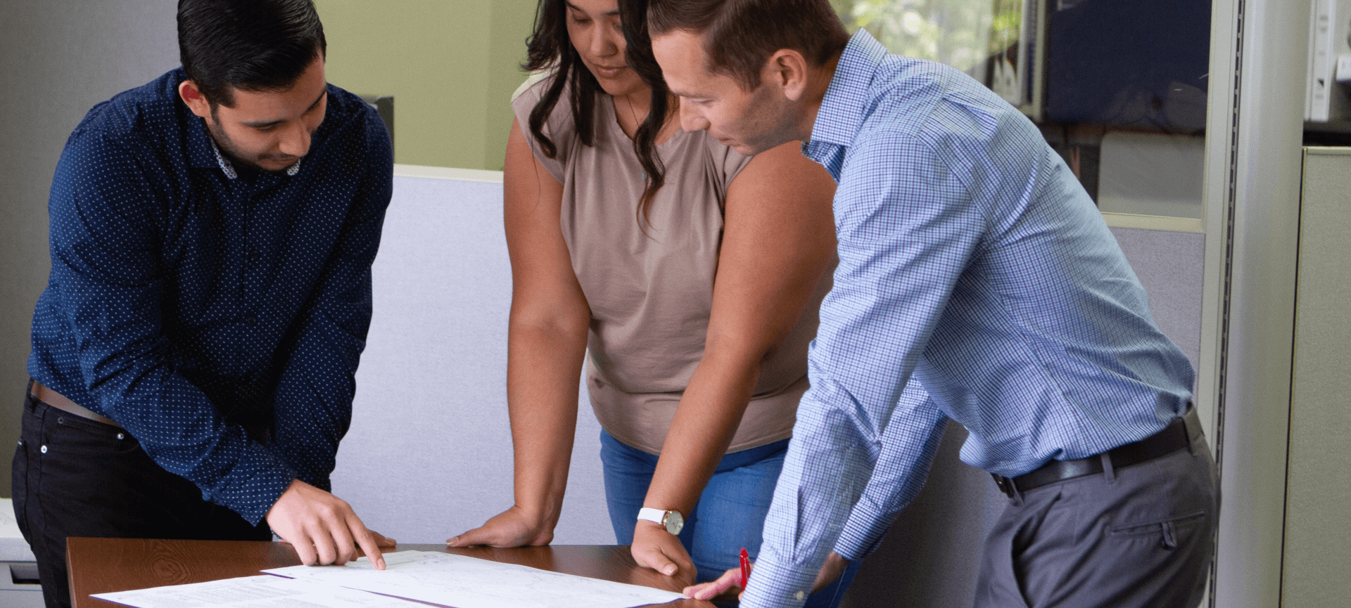 Team looking over plans on a table