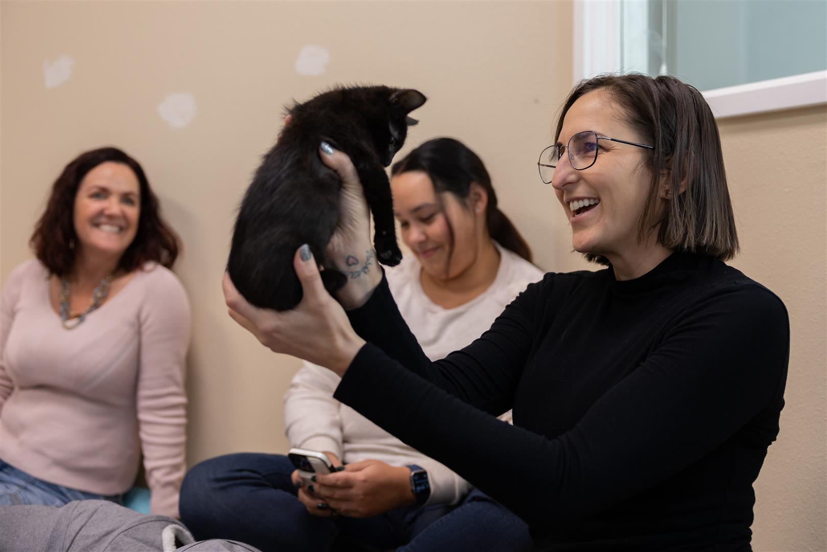 Rebecca Neuren holding a black kitten