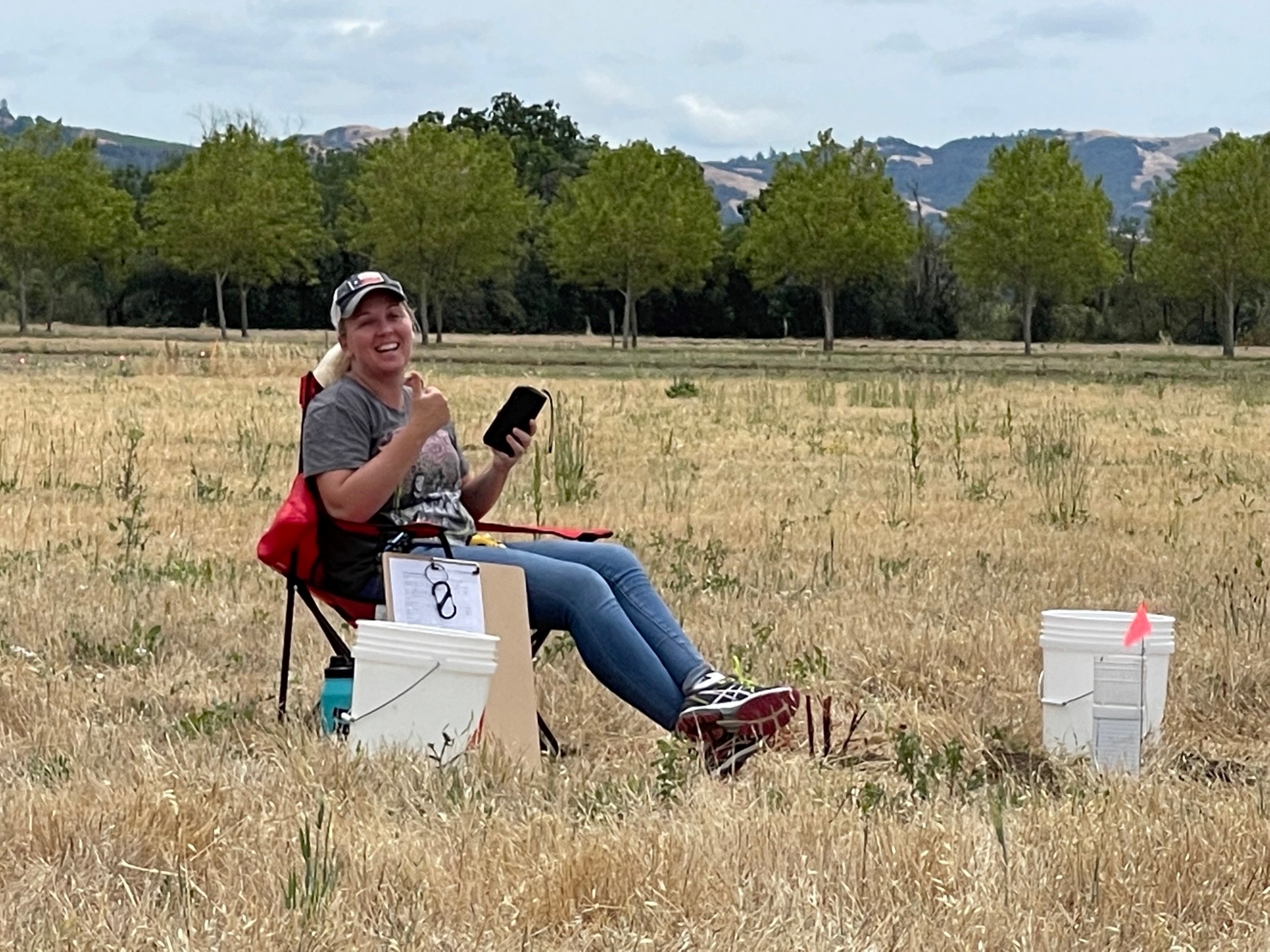 Tiffany Foster sitting in a field