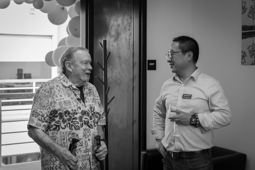 Black and white image of two people talking