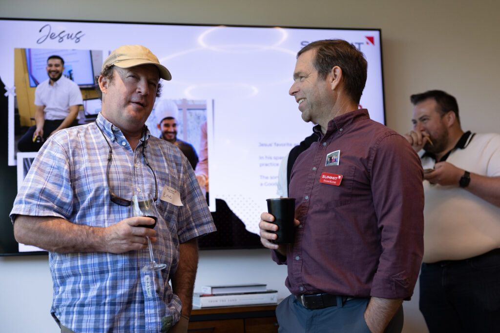 Two people talking at office event